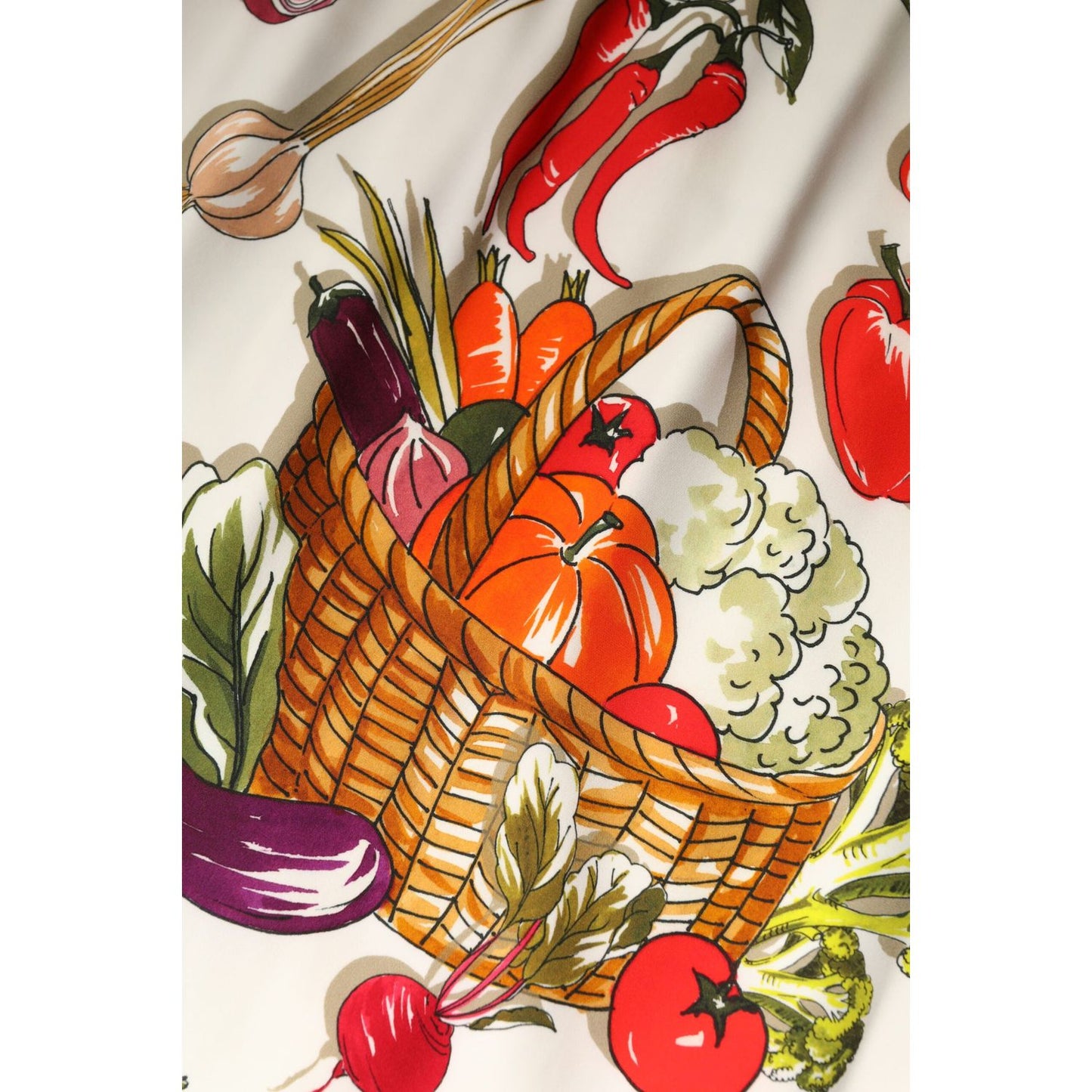 Dolce & Gabbana skirt fabric with colorful vegetable print, featuring peppers, pumpkin, tomatoes, radish, eggplant, and a wicker basket.