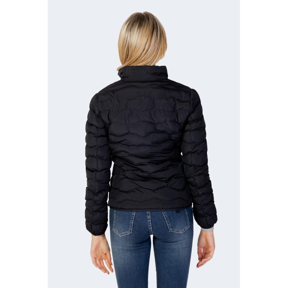 Back view of woman wearing EA7 Emporio Armani black polyester down jacket, showing quilted design and fitted style.